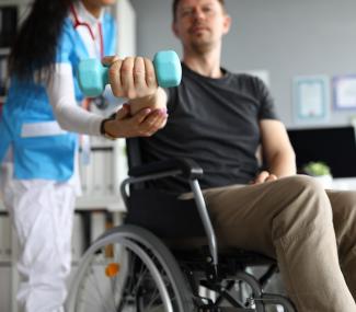 man in wheelchair with caregiver